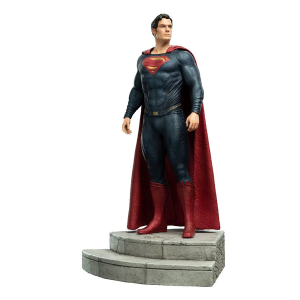 captured in a full-body close-up shot with Superman's arms and legs spread  out